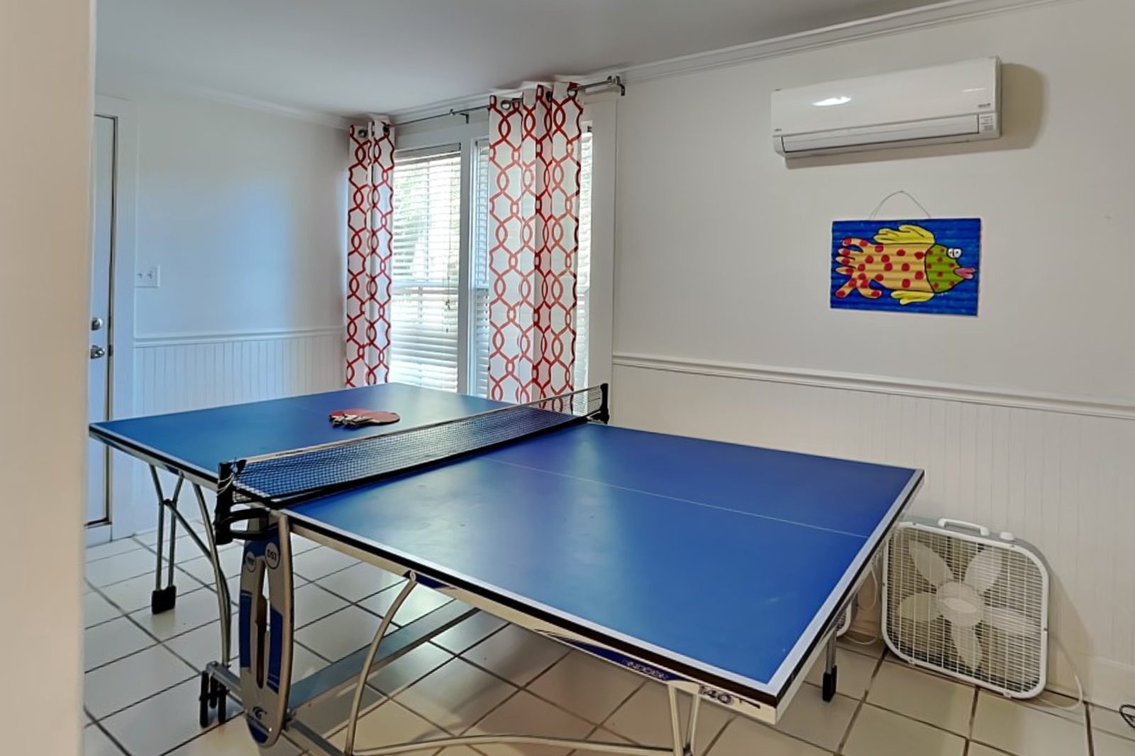 Ground-floor game room with a full-size ping-pong table